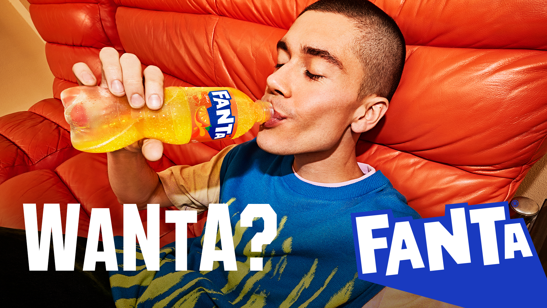 A man drinking Fanta