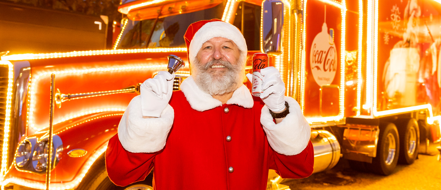 Santa vor dem Coca-Cola Xmas Truck