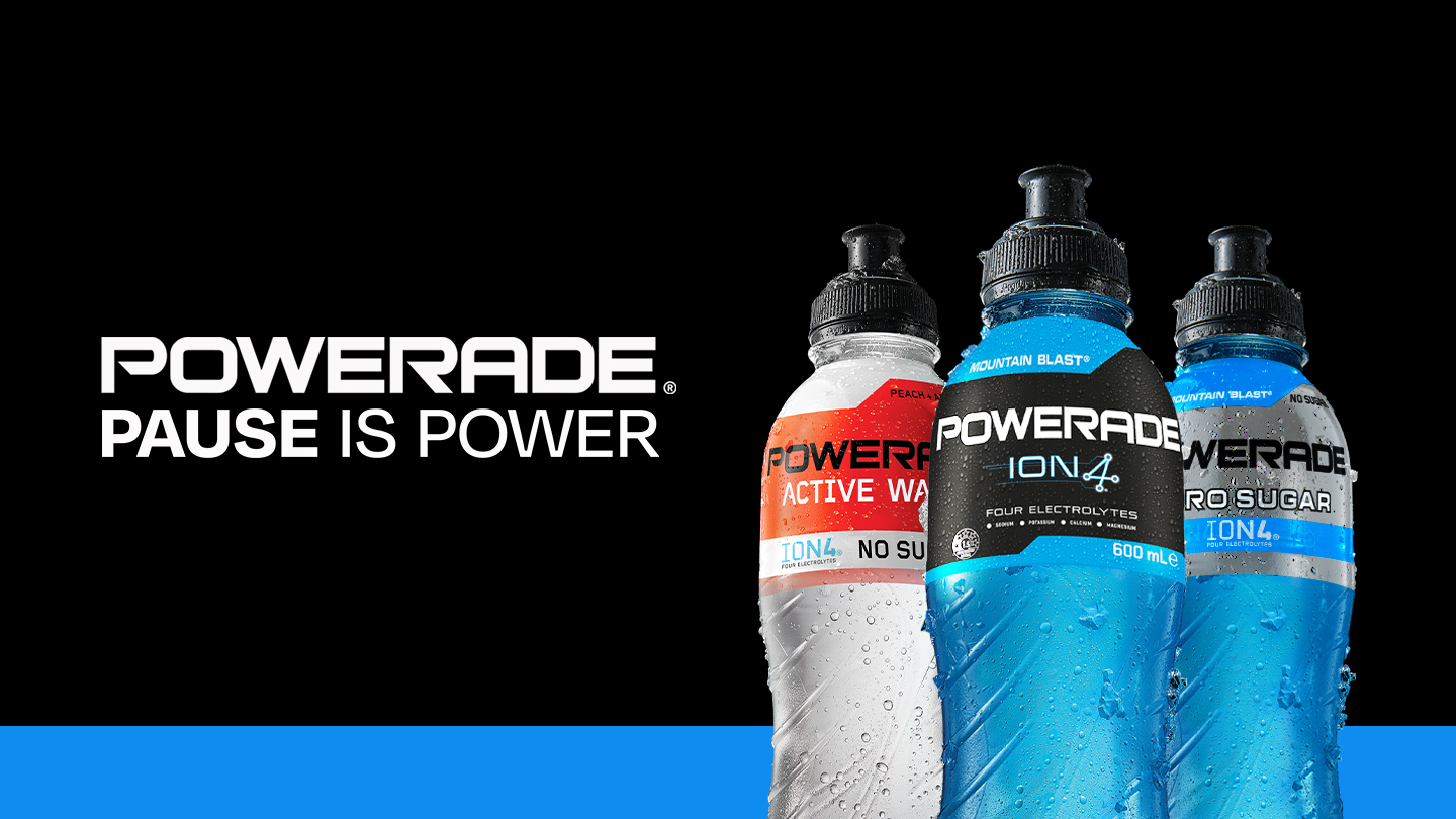 Variety of Powerade bottles in a black background