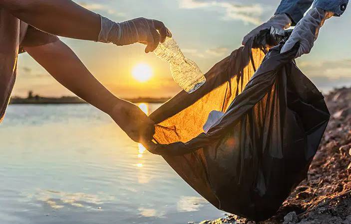 People collecting plastic waste in the sea shore