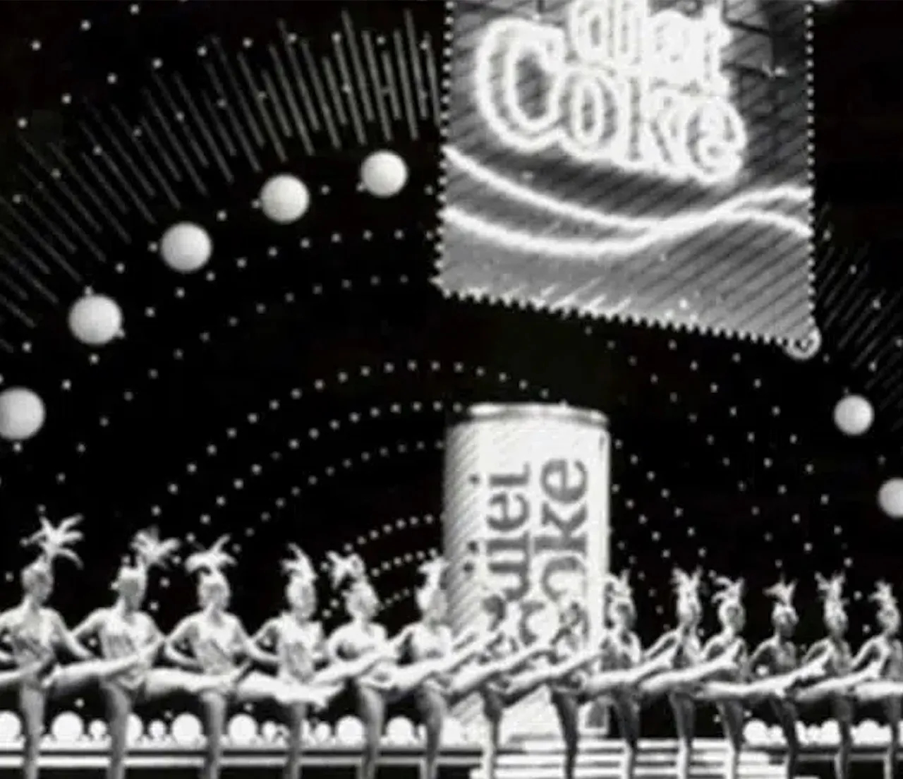 Antique black and white photograph of 1920's dance show with Diet Coke decoration