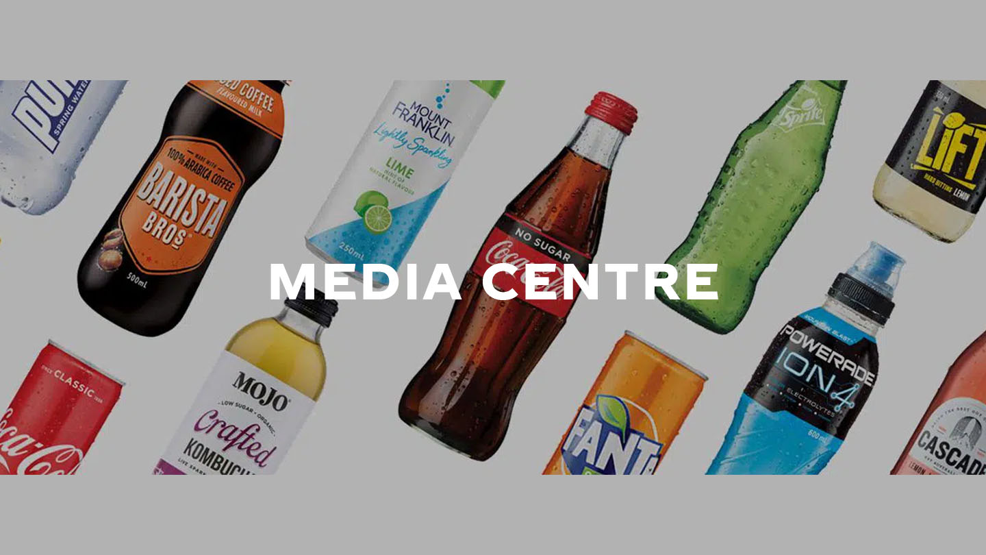Variety of bottles from the Coca-Cola brand in a white background with the phrase "Media Centre" in white
