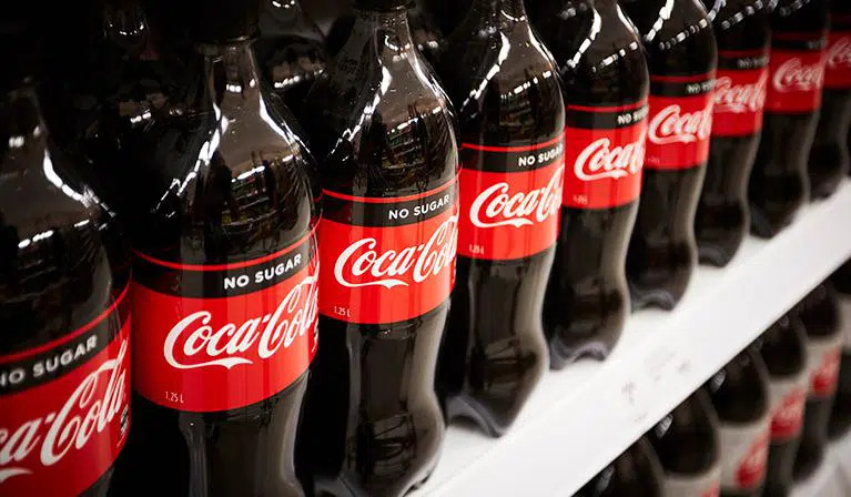 Multiple Coca-Cola No Sugar bottles on a supermarket shelf