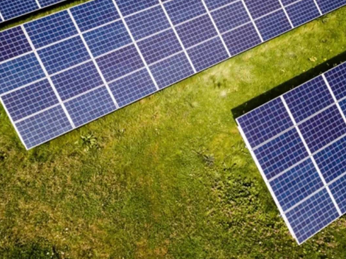Group of solar panels in an open field