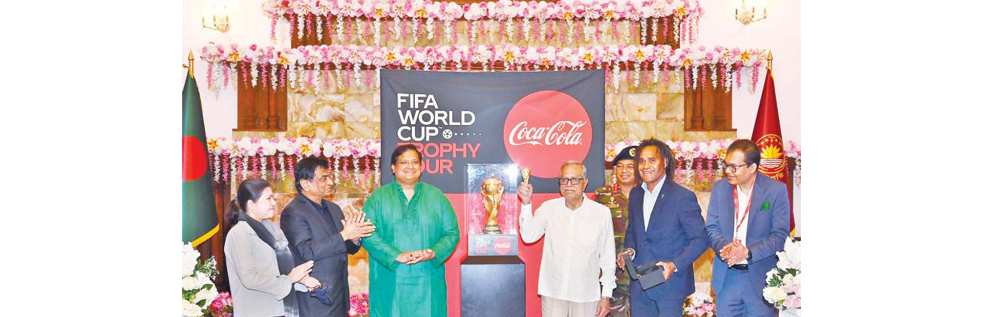 President Abdul Hamid standing by the FIFA World Cup Trophy