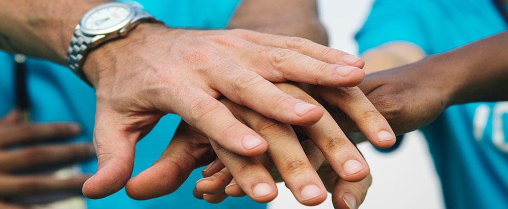 Detail of hands stacked together