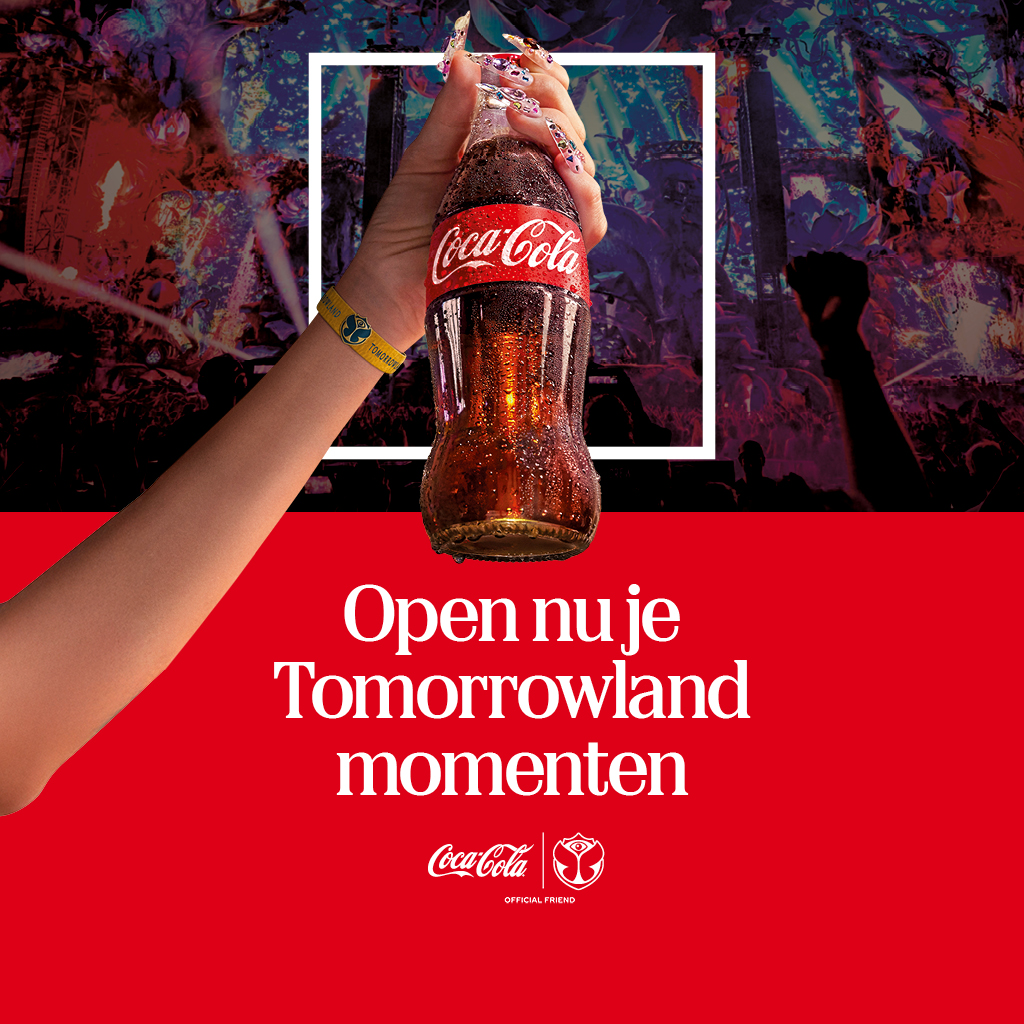 Een hand met een festivalbandje houdt een Coca‑Cola‑fles omhoog voor een kleurrijke festivalmenigte, met een wit kader en een rode banner met promotionele tekst.