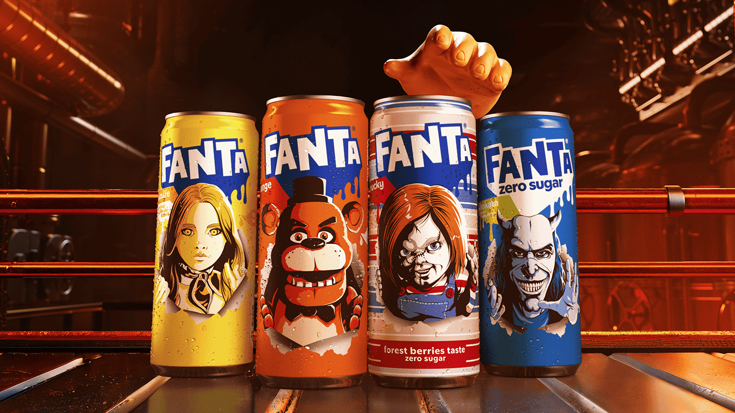 Vier Fanta-blikjes met verschillende smaken en ontwerpen, elk met kleurrijke illustraties van popcultuur- of spelpersonages op de voorkant. Van links naar rechts zijn de kleuren geel, oranje, wit-rood en blauw. Op de achtergrond is een industrieel decor zichtbaar en boven de blikjes steekt een hand omhoog.