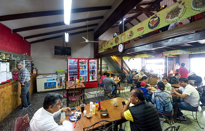 Personas comen en “La Le Li Lo Lu”, un restaurante de comida rápida tradicional