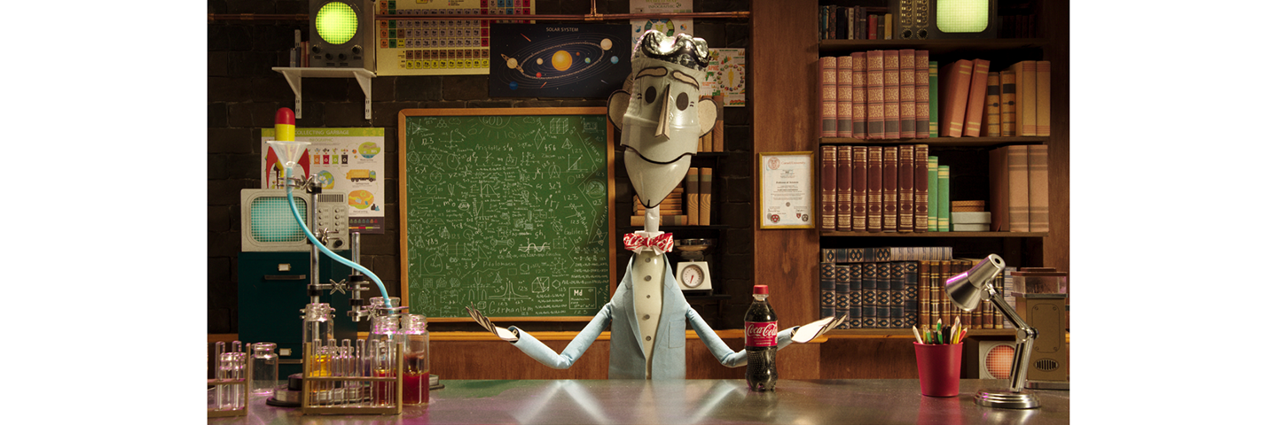 Movie still from the animated film made in collaboration between The Coca-Cola Company and Bill New. The still shows an animated character in a laboratory with a Coca-Cola plastic bottle