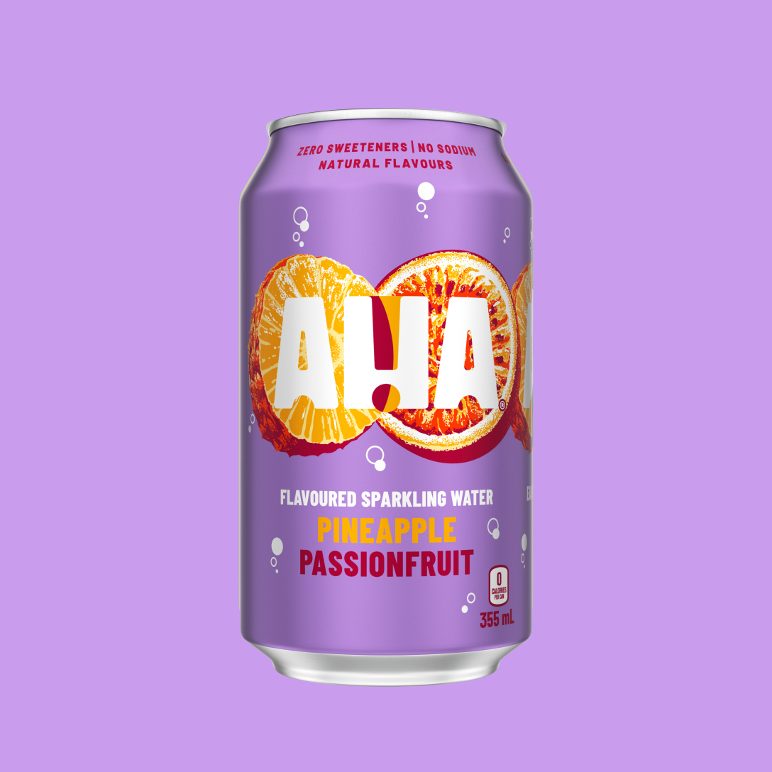 A lavender 355 mL can of AHA Pineapple Passionfruit flavoured sparkling water, with an illustrated pineapple slice and passionfruit half behind the white AHA logo. Text on the can reads "Zero sweeteners | No sodium | Natural flavours" and "0 calories per can," shown on a matching purple background.