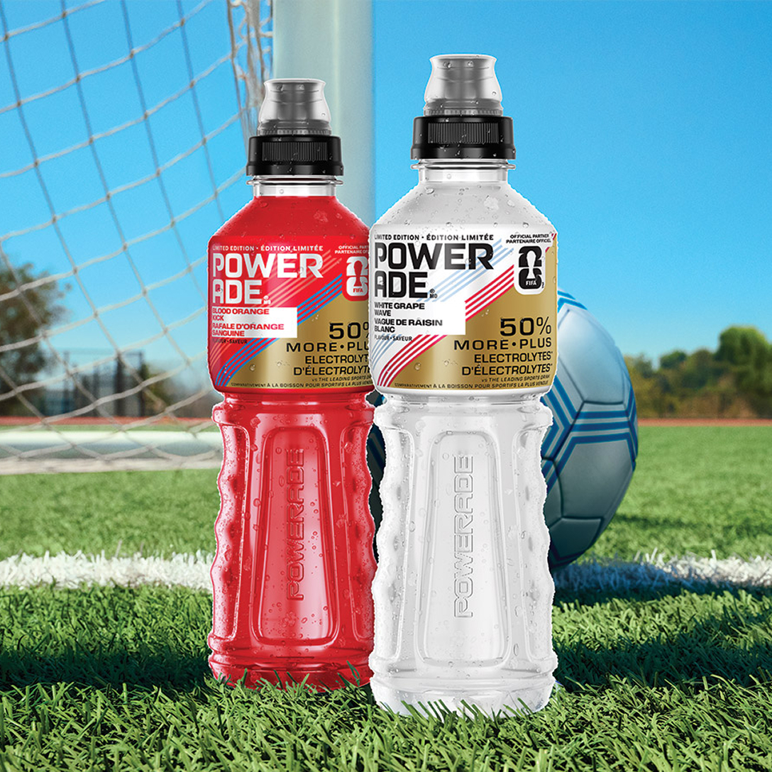 blood orange kick and white grape wave bottles on soccer field