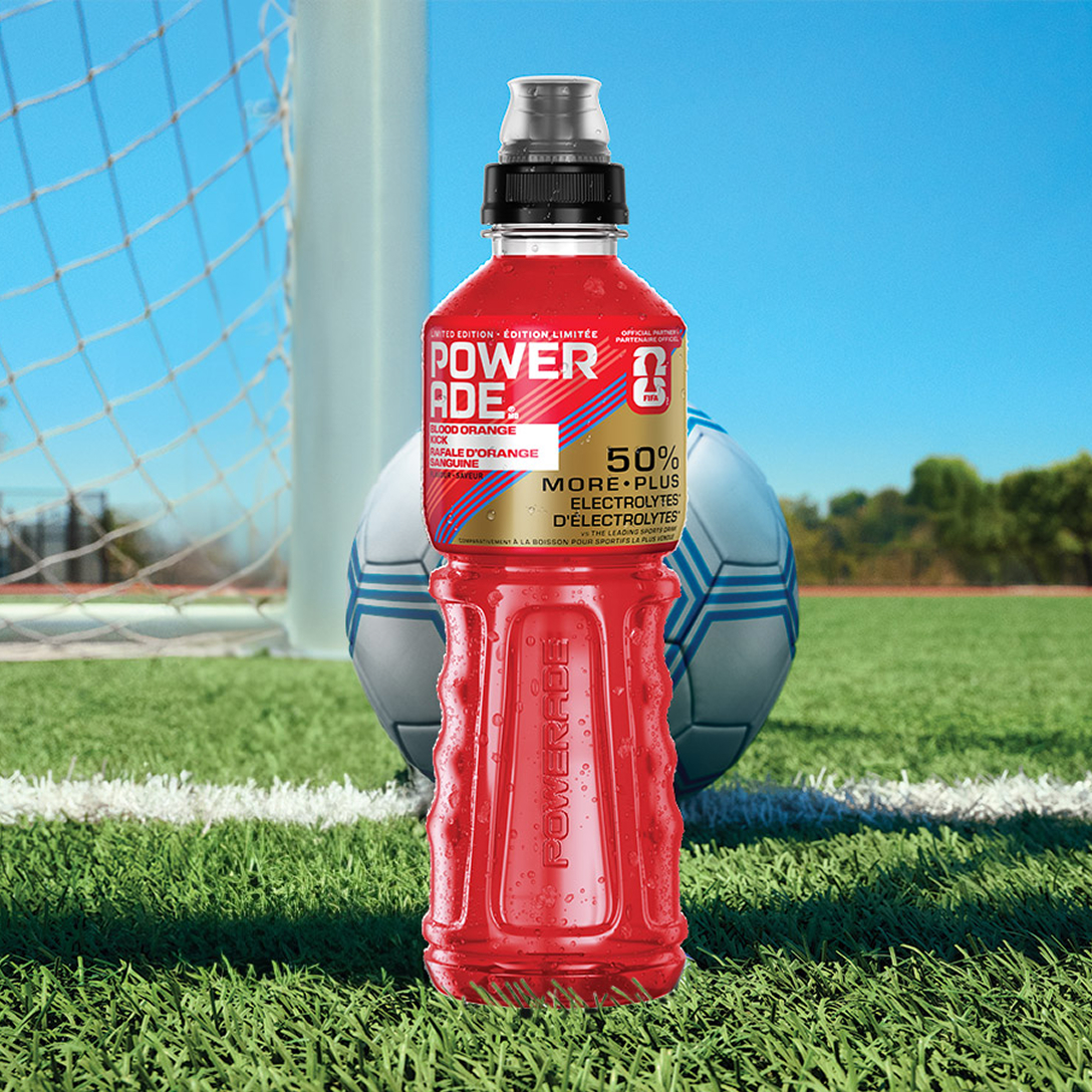 a bottle of blood orange kick on a soccer field