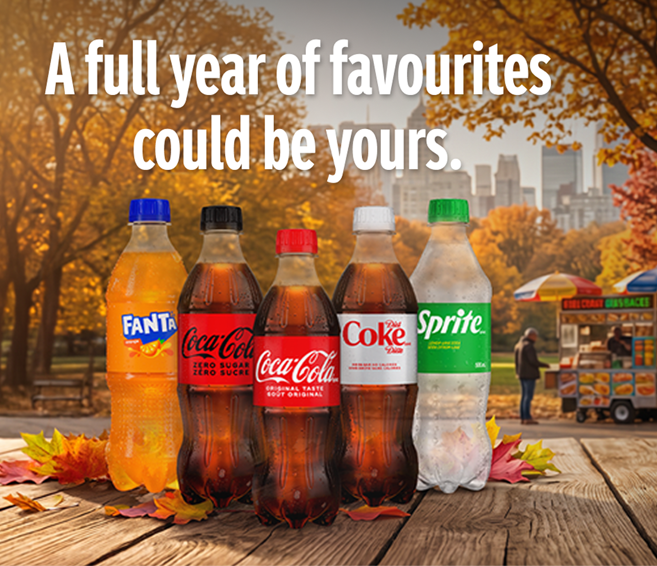 Assorted Coca-Cola beverages on an autumn park table promoting a chance to win a full year of favourites.