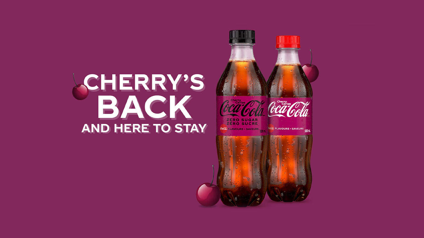 Two bottles of Coca-Cola Cherry on burgundy background with the slogan "Cherry's back and here to stay"