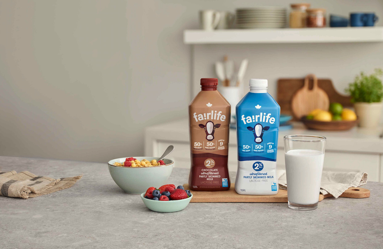 A fairlife® milk packaging, a glass of milk and a cereal bowl side by side