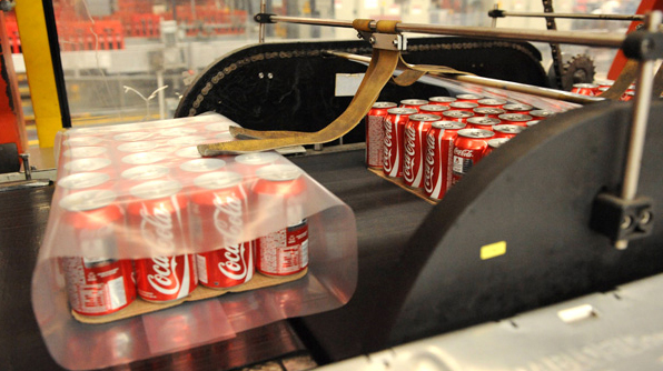 Coca-Cola cans in a factory treadmill