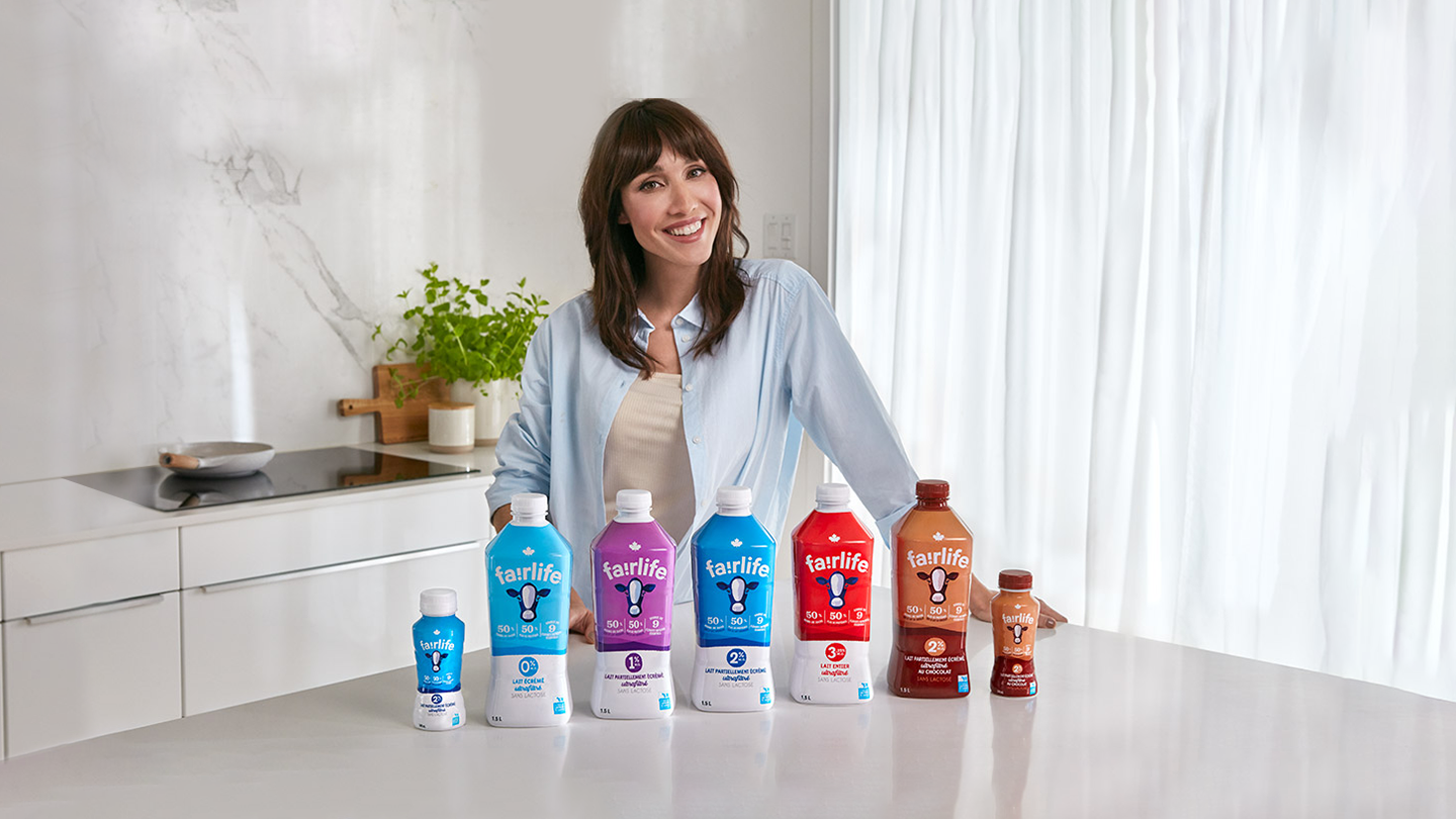 Vijaya Selvaraju smiling with some fairlife® examples placed in front of her 