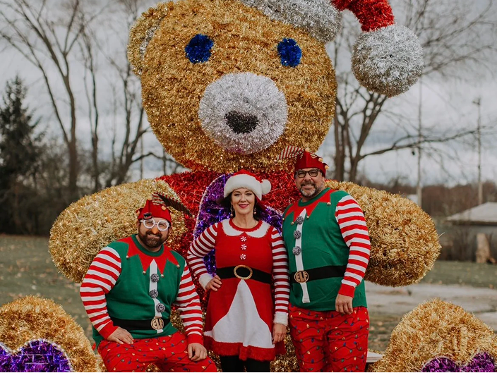 people in front of large teddy bear