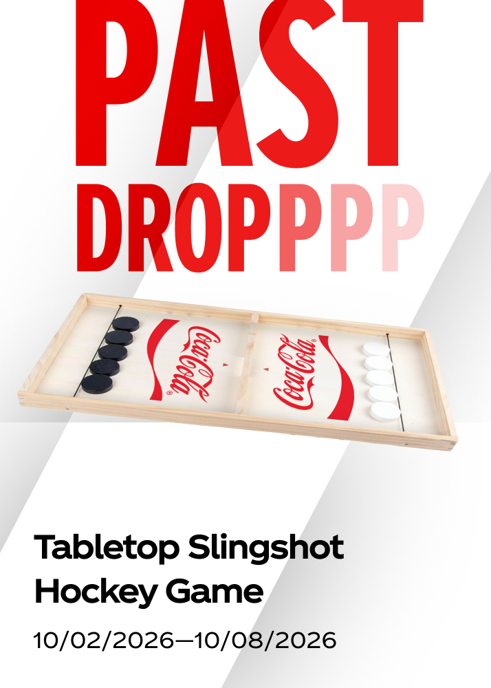 A wooden tabletop slingshot hockey game shown as a past drop for the Coca-Cola promo.