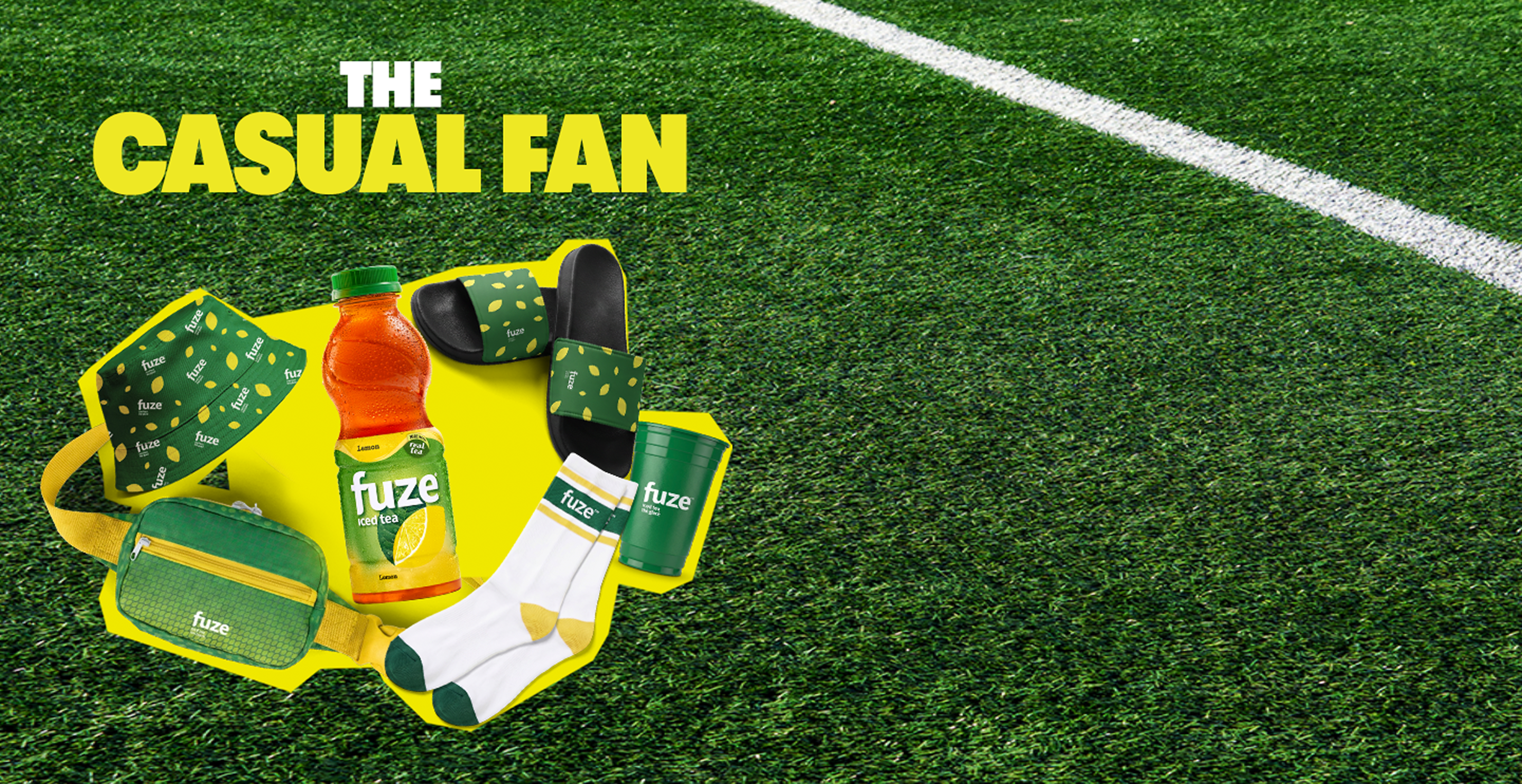The Casual Fan prize kit showing Fuze iced tea, belt bag, hat, slides, socks and cup on soccer field background