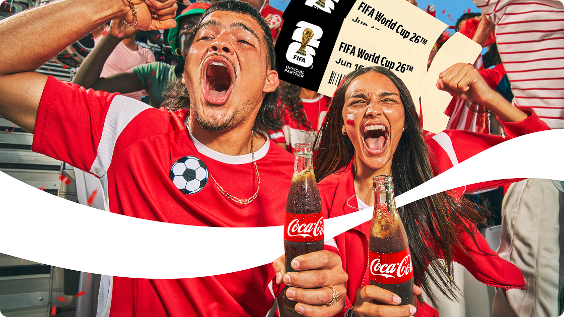 Two excited fans in a stadium celebrate with Coca-Cola bottles and FIFA World Cup 26™ tickets.