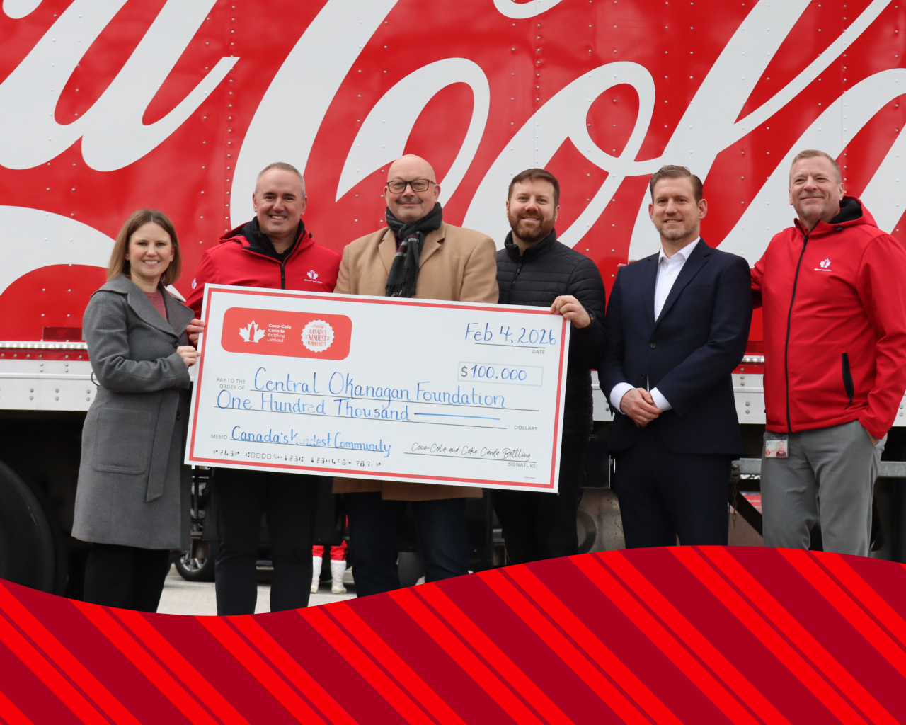 A group of people holding a check for winning Canada's Kindest community 2025