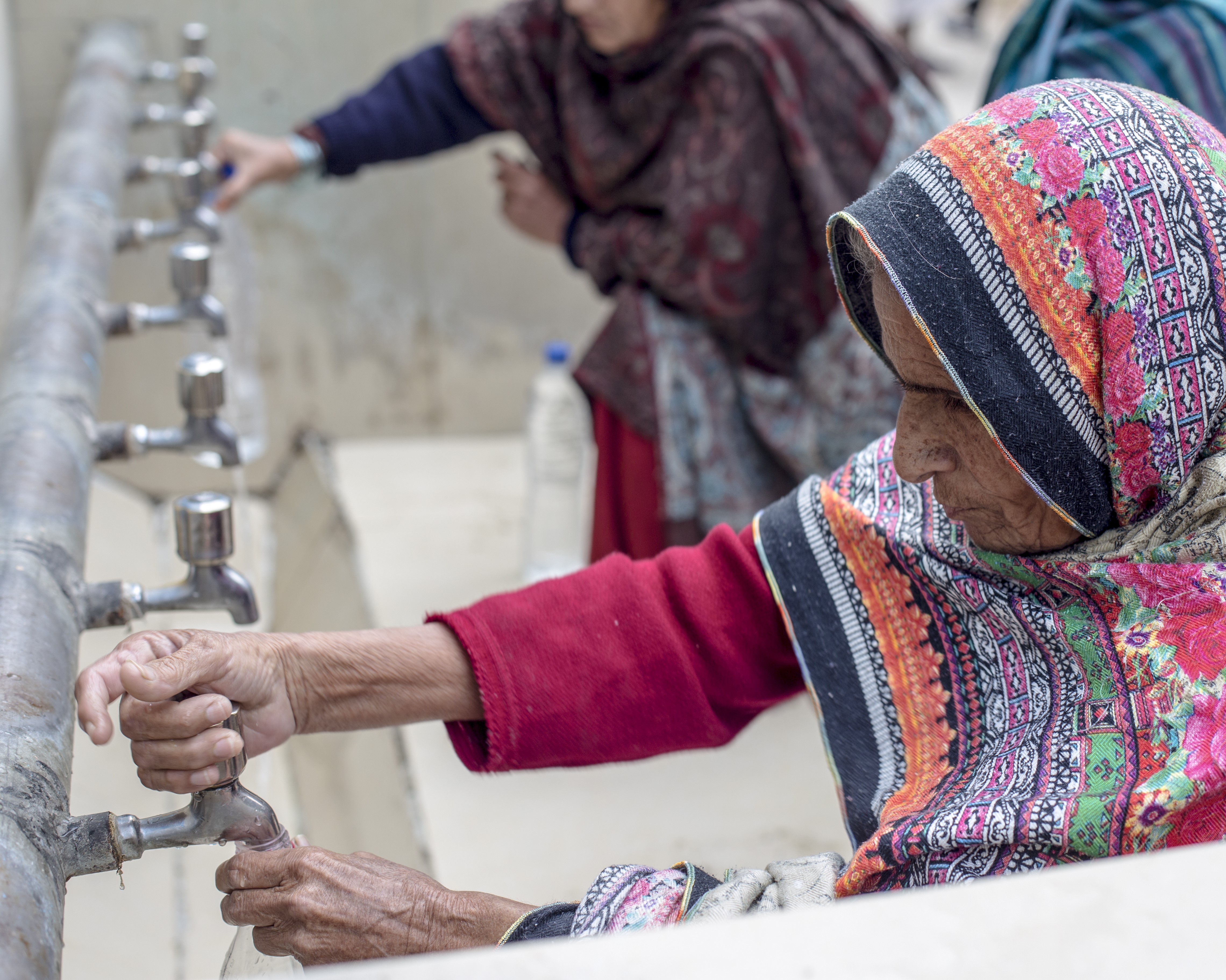 Villagers in Pakistan wash their hands with clean water harvested from rain