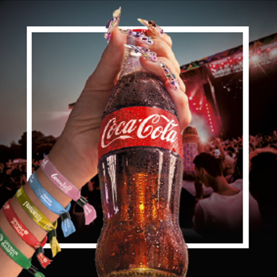 Un grand camion rouge décoré aux couleurs et lumières de Noël de Coca‑Cola.