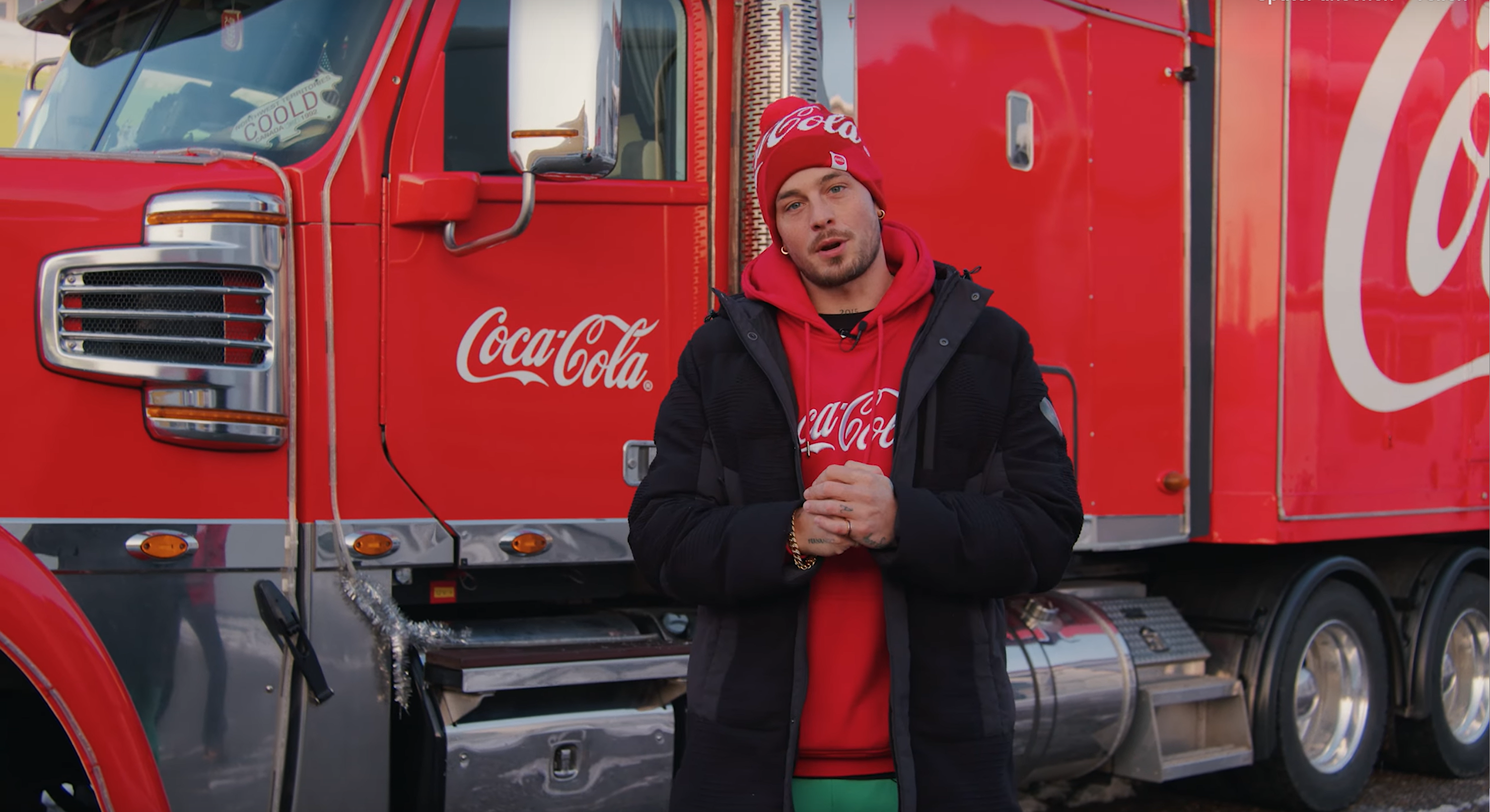 Loco Escrito standing in front of the coca-cola truck