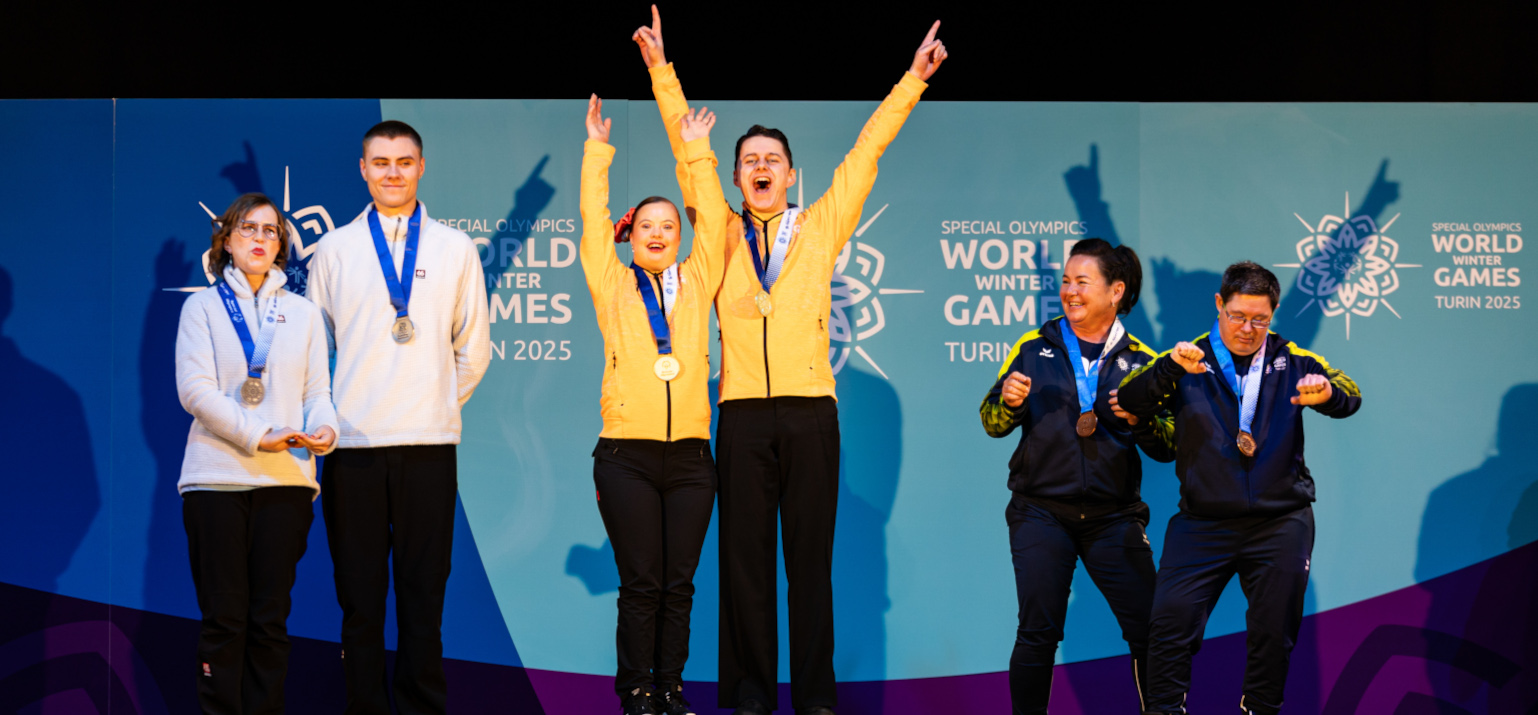 People cheering because they won a medal in dance sport