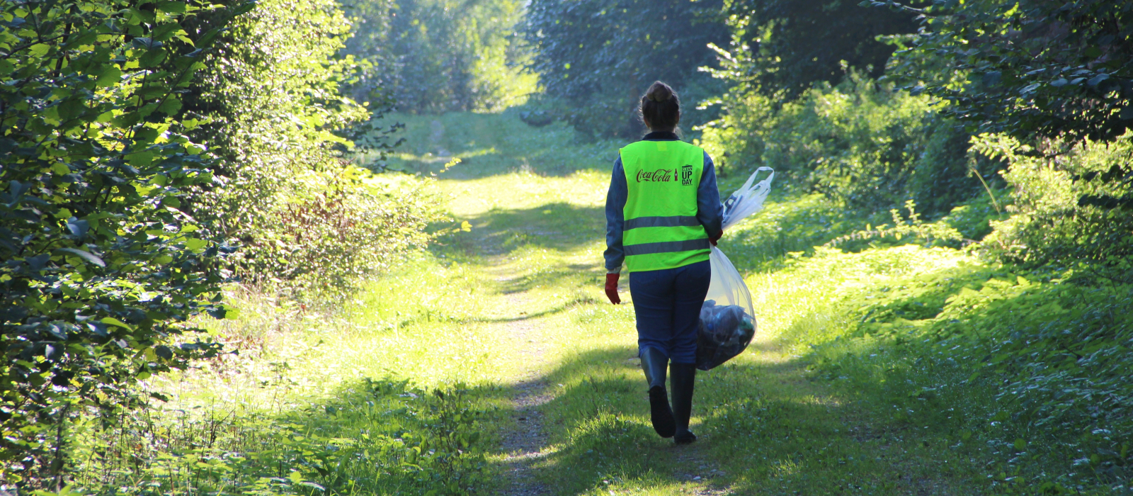 Mitarbeiterin von Coca-Cola in der Natur am Cleanup Day