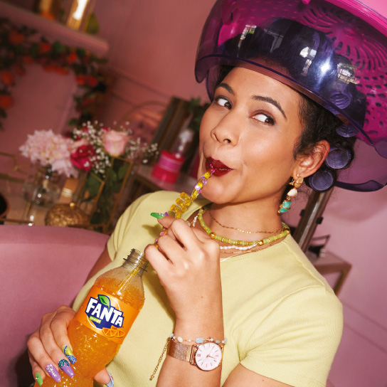 Woman drinking Fanta through straw