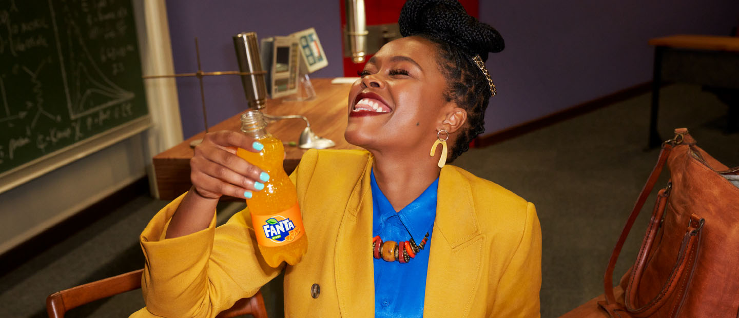 Woman drinking Fanta through straw