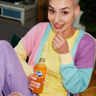 Woman drinking Fanta and eating popcorn