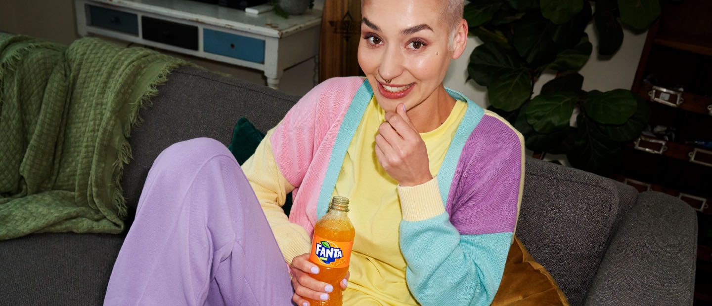 Woman drinking Fanta and eating popcorn