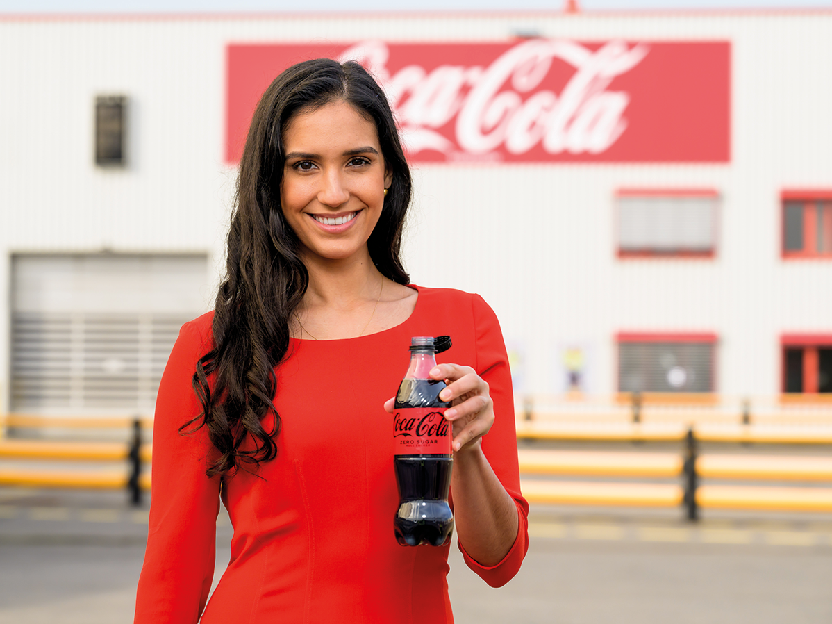 Frau mit Coca-Cola Zero Sugar Flasche