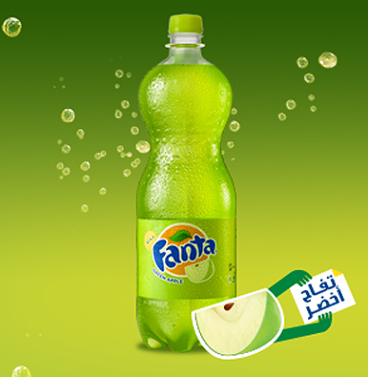 Fanta Green Apple bottle on greend background with green apple slice