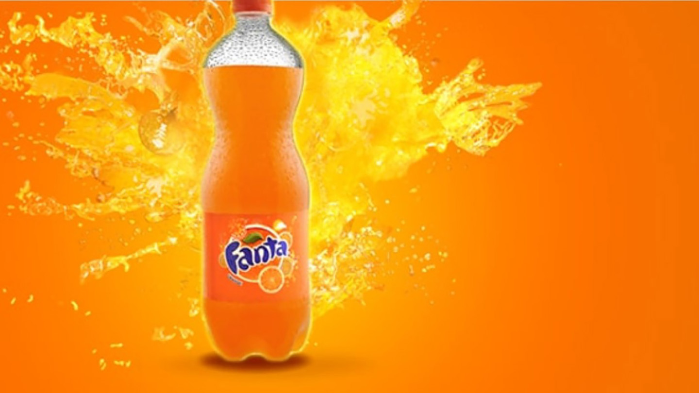 Fanta Orange bottle on orange background