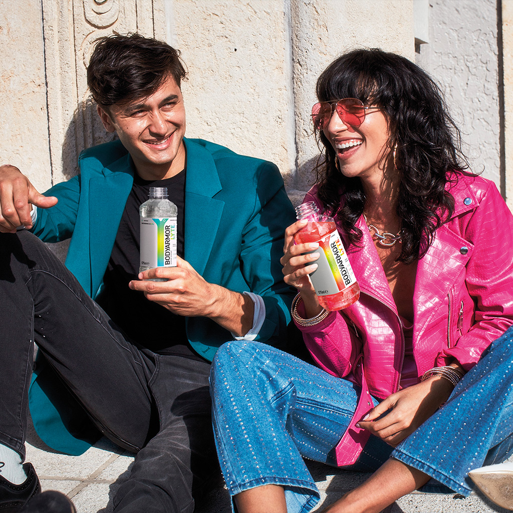 Chico sudando y bebiendo una botella de BodyArmour Lyte sabor Coco