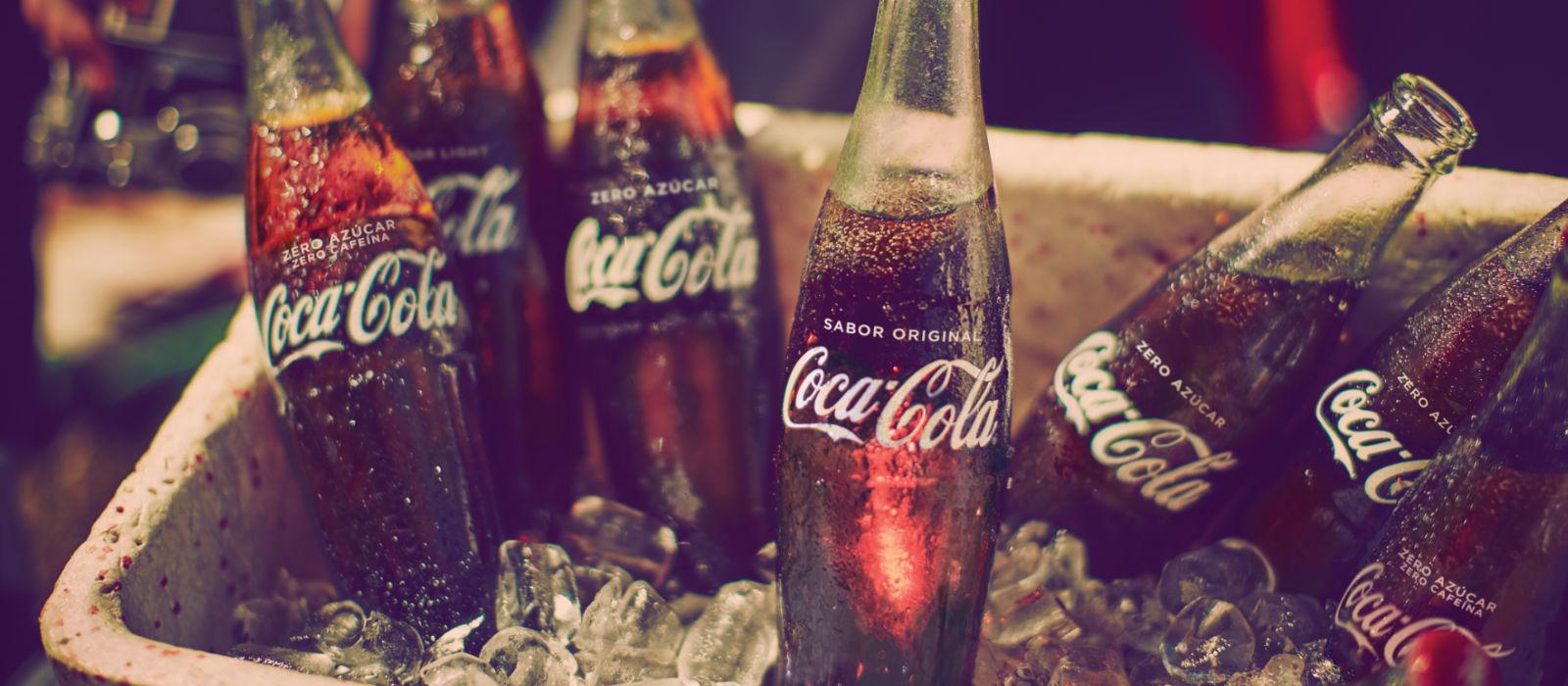 Cubo con hielo con seis botellas de Coca-Cola