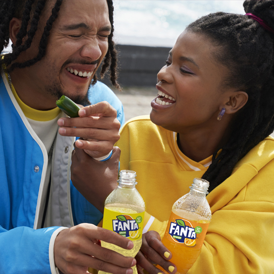 Woman drinking Fanta through straw