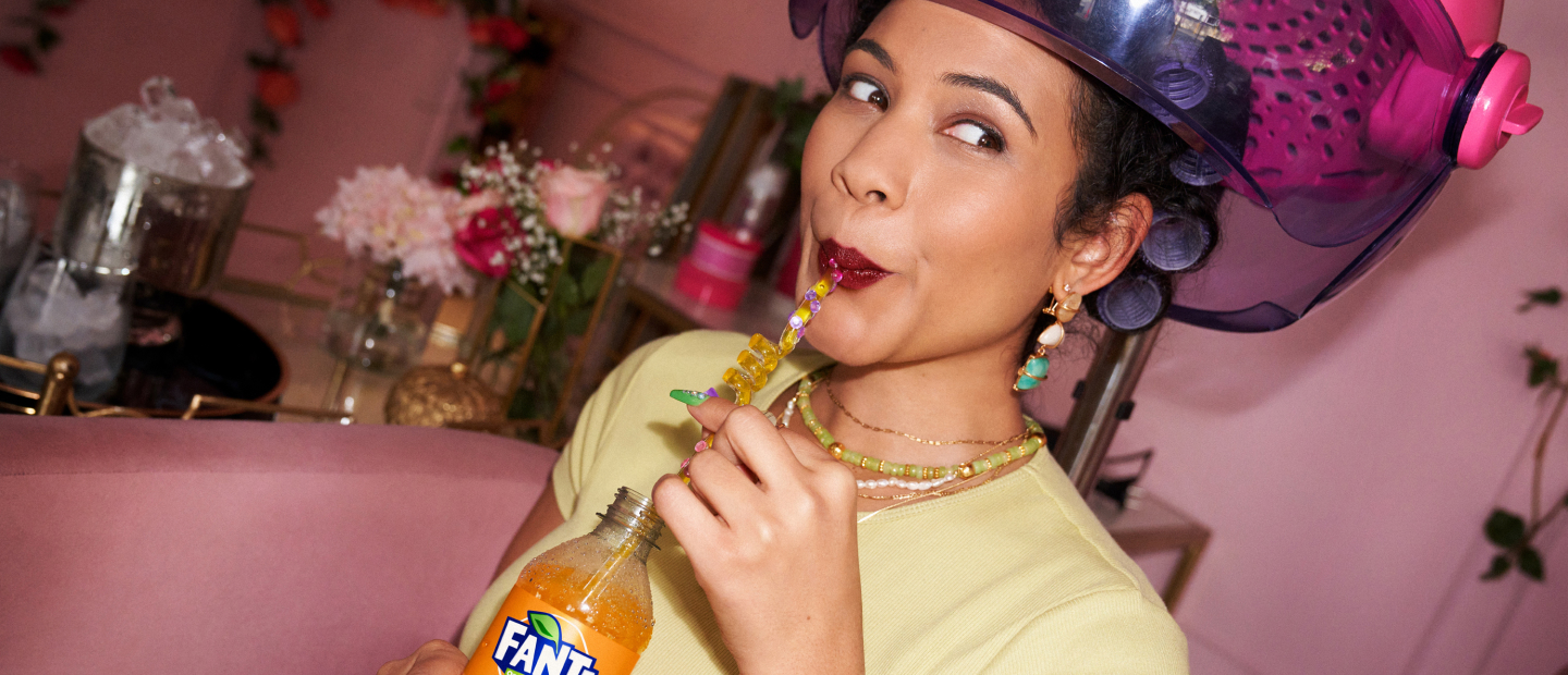 Woman drinking Fanta through straw