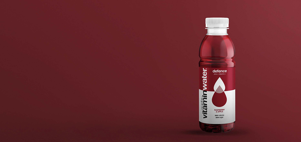 GLACÉAU Vitaminwater bottle on dark red background.
