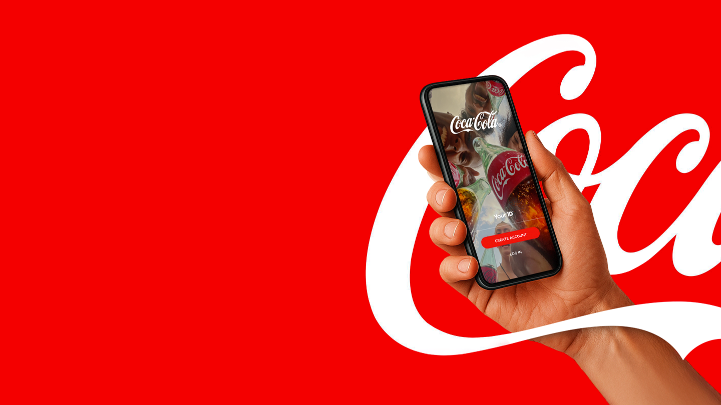 A hand holding mobile phone with the Coca-Cola App