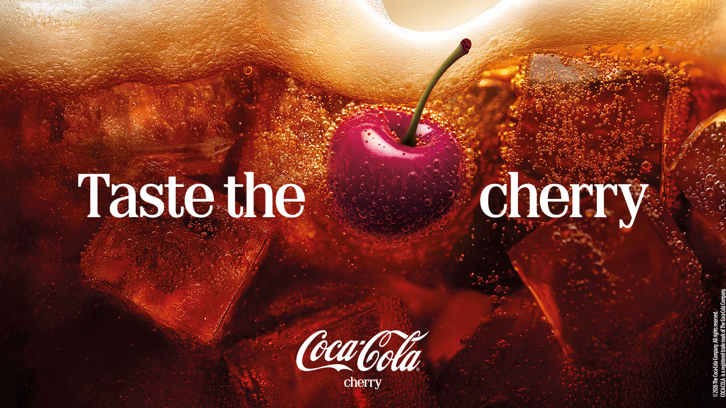 sparkling drink with ice cubes and cherry, with text saying taste the cherry 