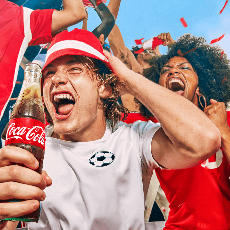Football fans celebrating with Coca-Cola