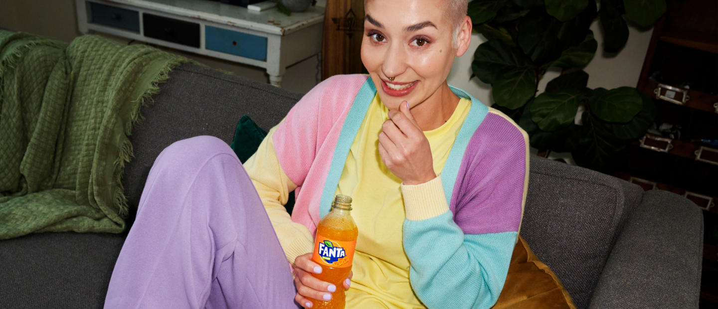 Woman drinking Fanta and eating popcorn