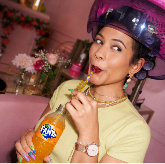 Woman drinking Fanta through straw