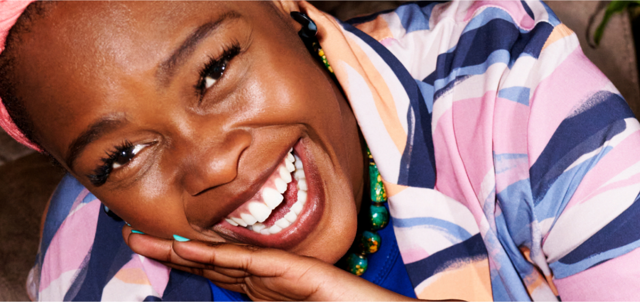 Woman laughing and drinking fanta